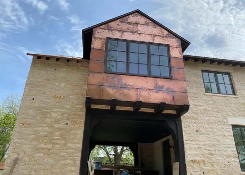 Copper metal panel facade on a stone building for Metal Roof Coating in Osprey