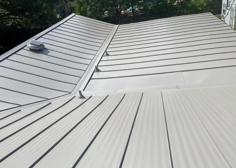 Solar attic fan installed on a metal roof for Roof Ventilation in Osprey